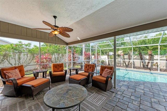 sunroom featuring vaulted ceiling, plenty of natural light, and ceiling fan