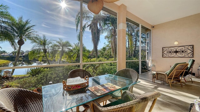 sunroom with plenty of natural light and a water view