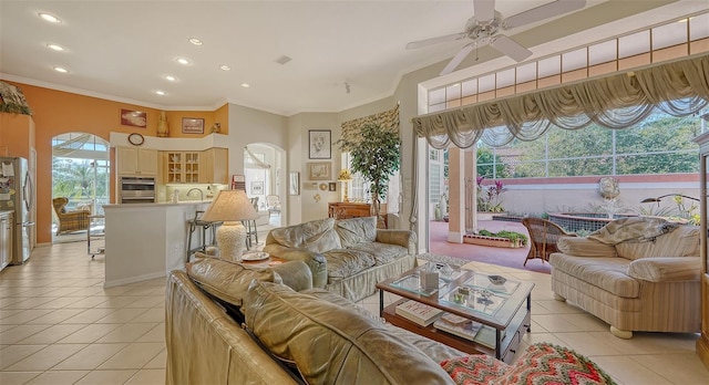 tiled living room with sink, ornamental molding, and ceiling fan