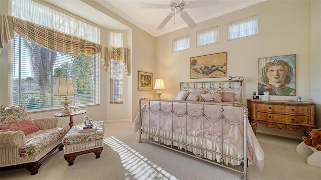 carpeted bedroom with multiple windows, crown molding, and ceiling fan