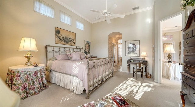 carpeted bedroom featuring a towering ceiling, ornamental molding, and ceiling fan