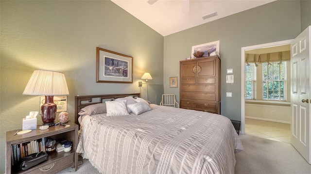 bedroom featuring vaulted ceiling, light tile patterned floors, and ceiling fan