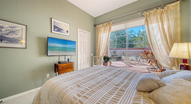 carpeted bedroom featuring access to exterior and vaulted ceiling