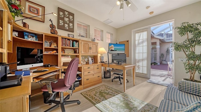 office with ceiling fan and light hardwood / wood-style floors