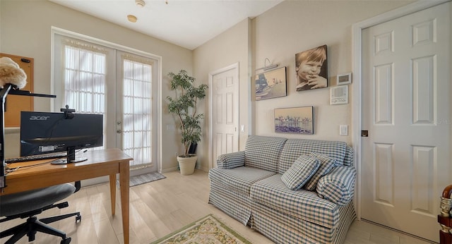 office area featuring a wealth of natural light, light hardwood / wood-style floors, and french doors