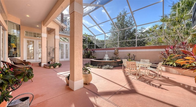 view of patio with glass enclosure and french doors