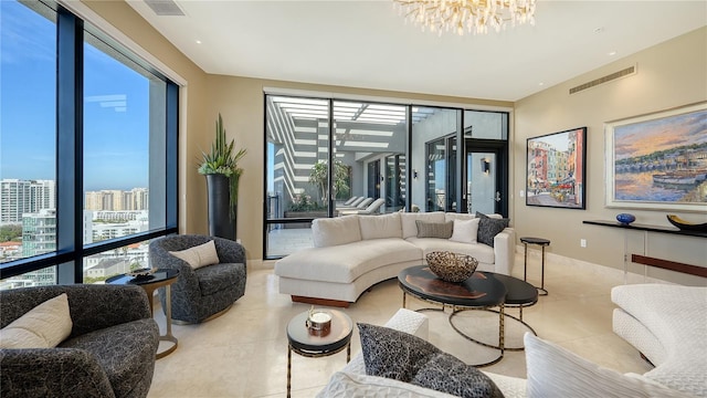 tiled living room with a notable chandelier