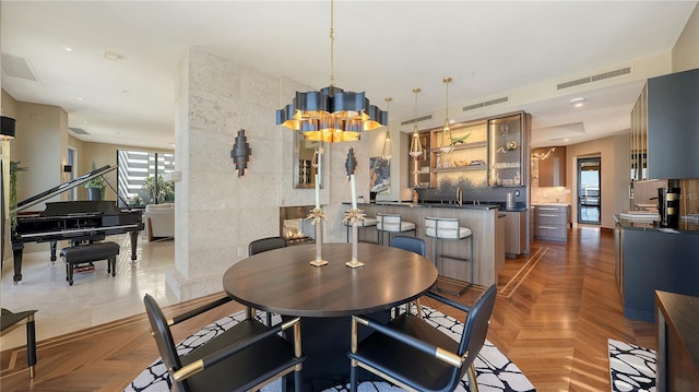 dining space with dark parquet flooring