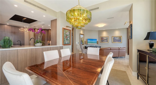 dining space with sink and a chandelier