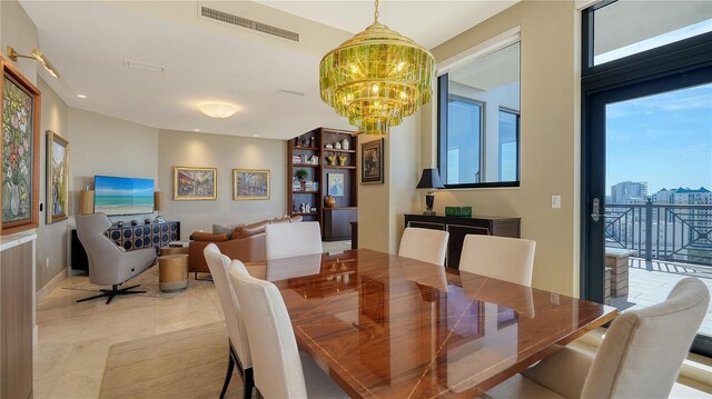 tiled dining room featuring an inviting chandelier