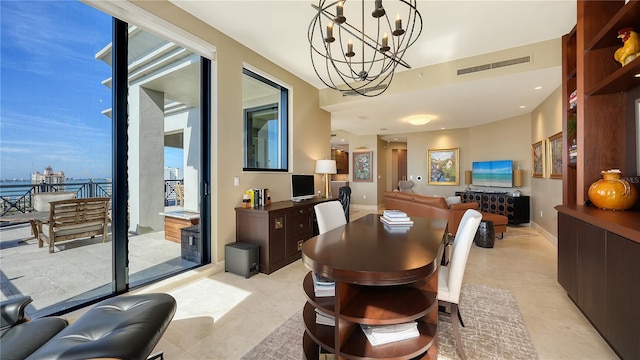 dining space featuring a healthy amount of sunlight and an inviting chandelier