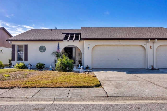 ranch-style house with a garage and a front yard