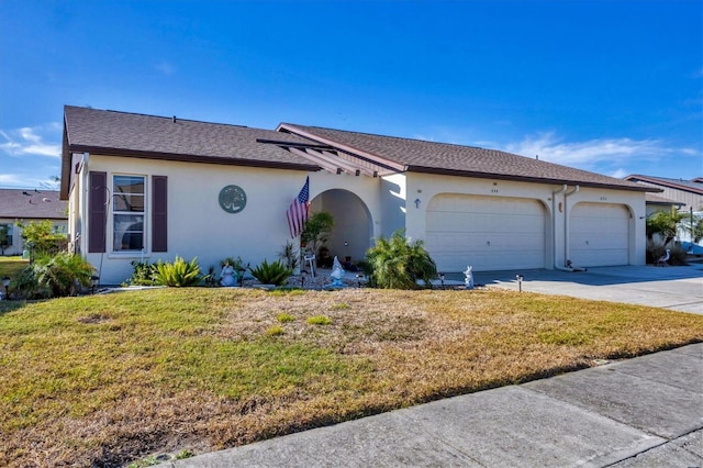 ranch-style house featuring a garage and a front yard