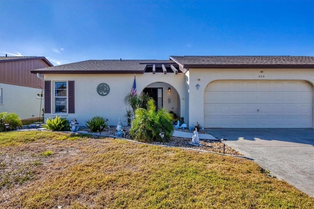 single story home featuring a garage and a front lawn