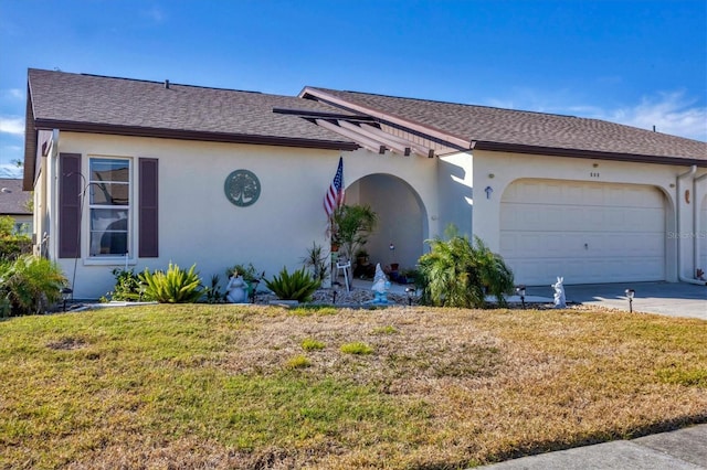 ranch-style home featuring a garage and a front lawn