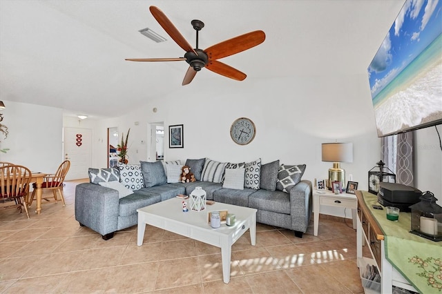 living room with vaulted ceiling, light tile patterned floors, and ceiling fan