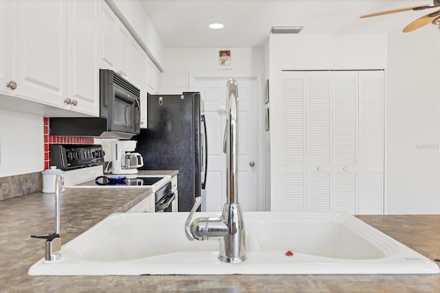 kitchen with ceiling fan, black appliances, and white cabinets