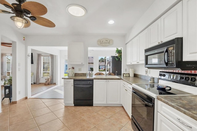 kitchen with light tile patterned flooring, sink, white cabinetry, a healthy amount of sunlight, and black appliances