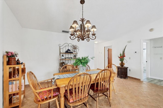 tiled dining area featuring a chandelier