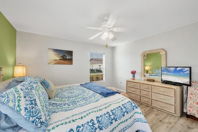 bedroom with light hardwood / wood-style flooring and ceiling fan