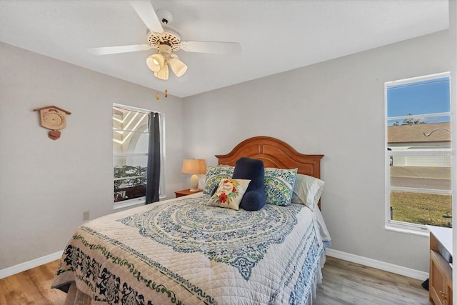 bedroom with ceiling fan and light wood-type flooring