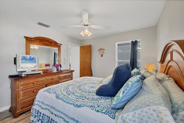 bedroom with ceiling fan and light wood-type flooring