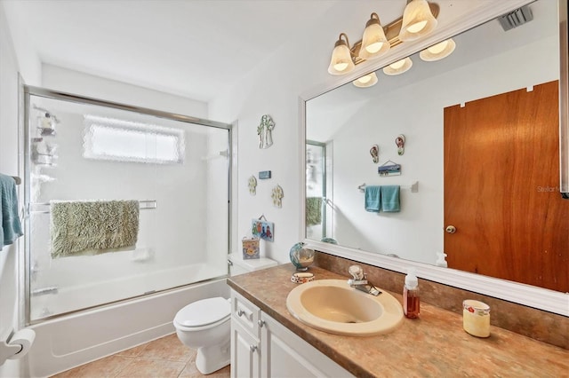 full bathroom with toilet, vanity, bath / shower combo with glass door, and tile patterned flooring