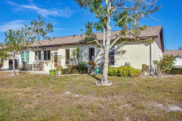 back of house featuring a yard and a patio