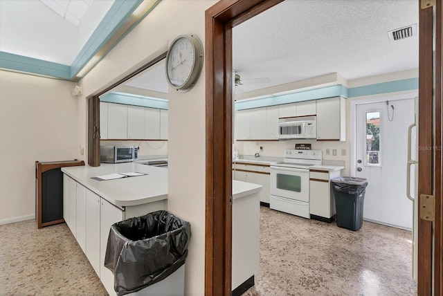 kitchen with ceiling fan, white appliances, a textured ceiling, and white cabinets