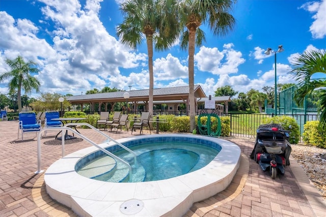 view of swimming pool with an in ground hot tub and a patio