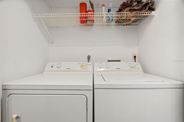 clothes washing area with washer and dryer