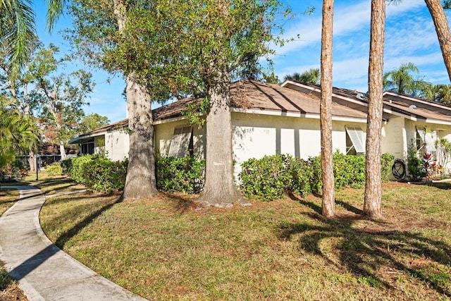 view of home's exterior with a lawn