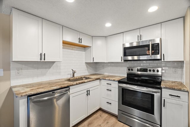 kitchen with white cabinetry, sink, and appliances with stainless steel finishes