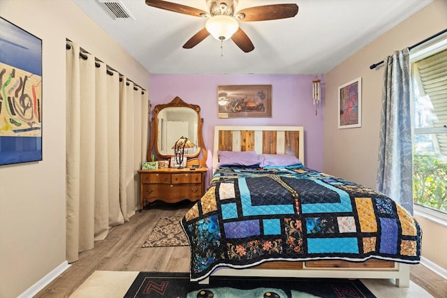 bedroom with ceiling fan and light wood-type flooring