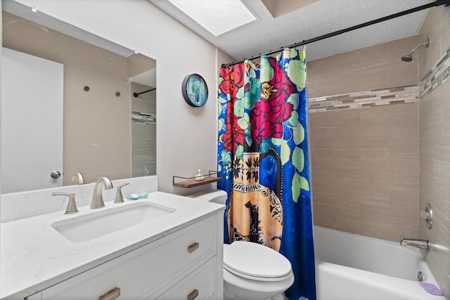 full bathroom with shower / bathtub combination with curtain, a skylight, vanity, a textured ceiling, and toilet