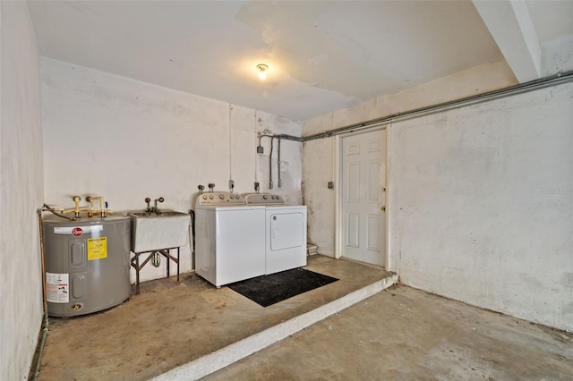 laundry room with water heater, washer and dryer, and sink