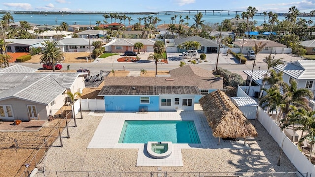 view of swimming pool featuring a water view and a patio area