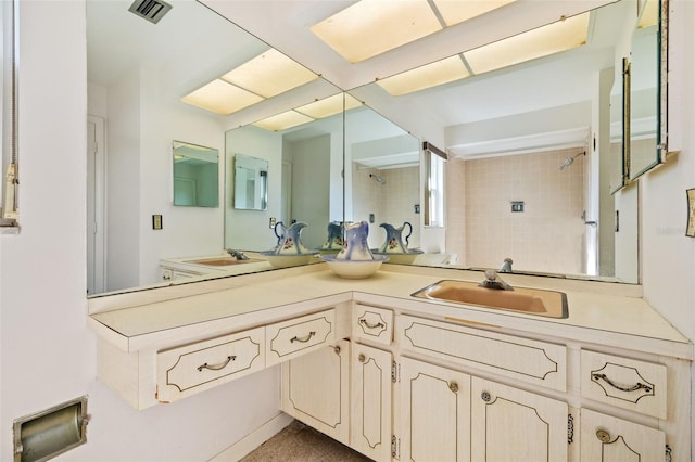 bathroom featuring vanity and a tile shower