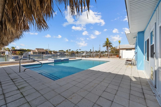 view of swimming pool with an in ground hot tub and a patio area