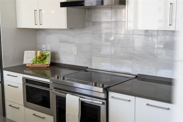 kitchen featuring white cabinets, wall chimney exhaust hood, and appliances with stainless steel finishes