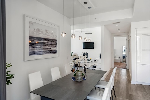 dining space with hardwood / wood-style floors