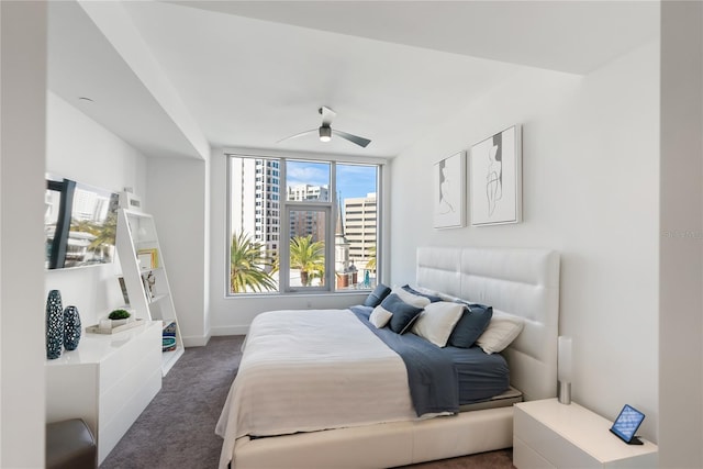 bedroom featuring ceiling fan and dark colored carpet