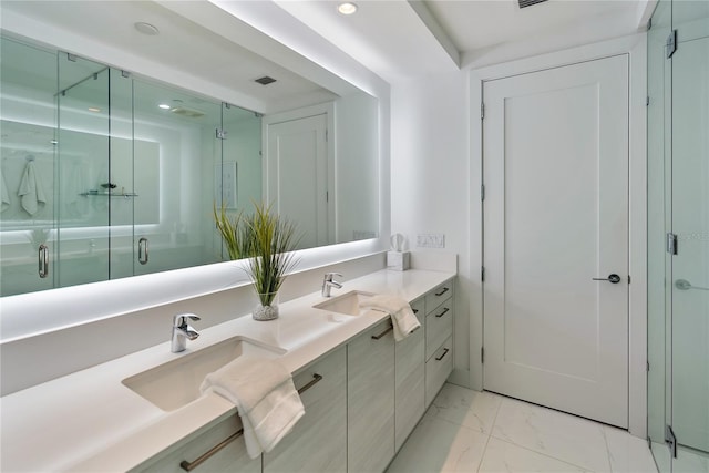 bathroom with vanity and a shower with shower door