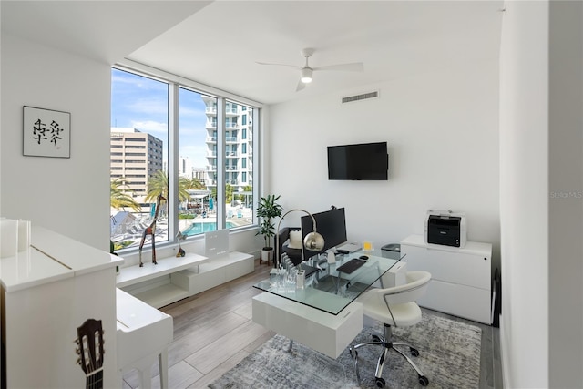 office space with ceiling fan and light hardwood / wood-style flooring