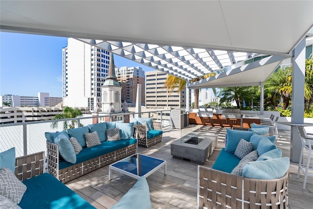 view of patio / terrace with a pergola and an outdoor living space with a fire pit