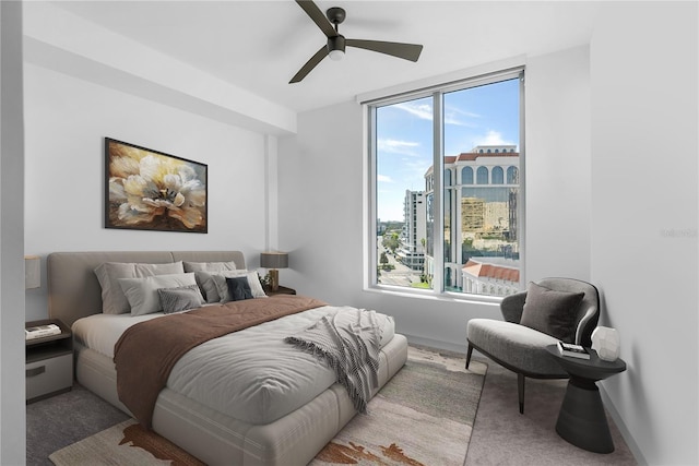 bedroom featuring light carpet and ceiling fan