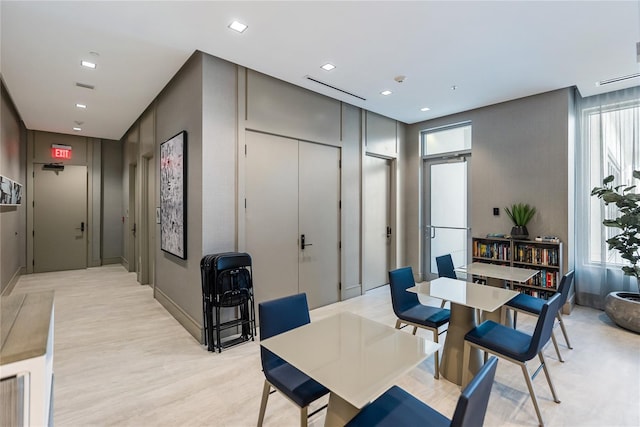 dining area featuring plenty of natural light and light wood-type flooring