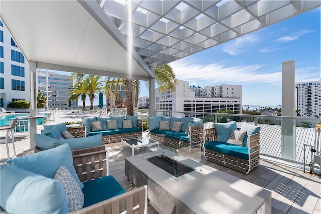 view of patio featuring an outdoor living space with a fire pit