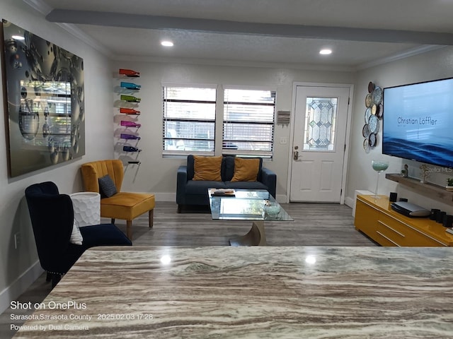 interior space with crown molding, wood-type flooring, and beam ceiling