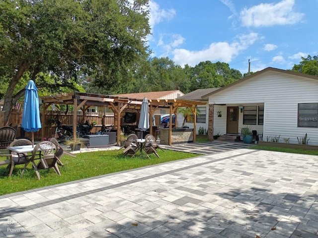 back of house with a yard, a pergola, and a patio